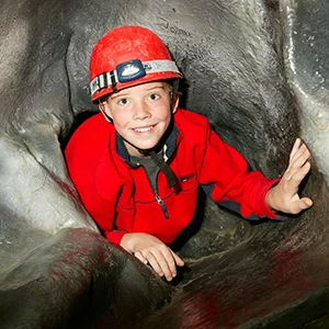 Child doing Caving at Robinwood Activity Centre
